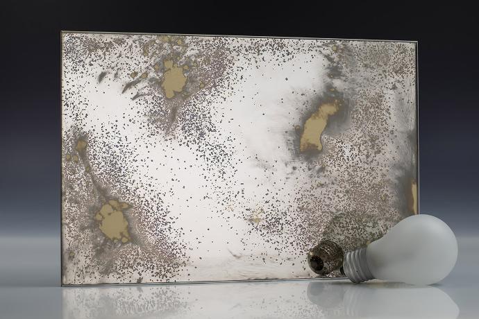 Open silver gold oxide - silver sedimentation - antique mirror - sample A square mirror piece with gold flecks and a light bulb on a neutral background