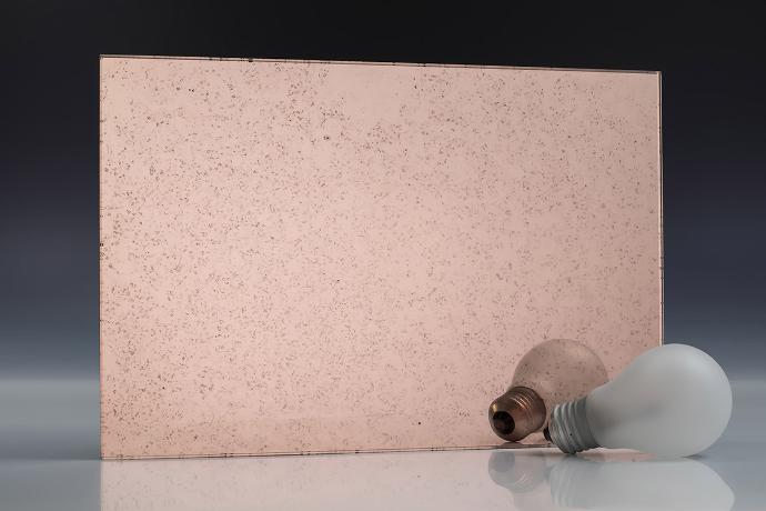 Fine copper grain - copper - antique mirror - sample A square piece of copper mirror with a patina and a light bulb on a neutral background
