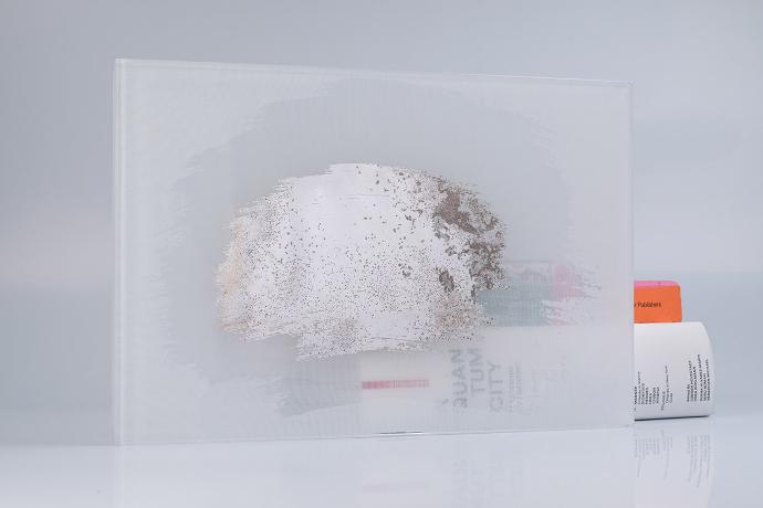 A square piece of white glass with a partial mirror and books on a neutral background