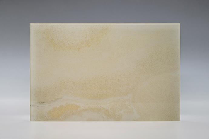 A square piece with the texture of a yellowish stone on a neutral background