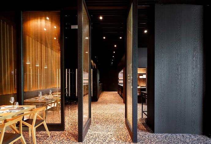 Modern restaurant interior with glass doors, table and chairs