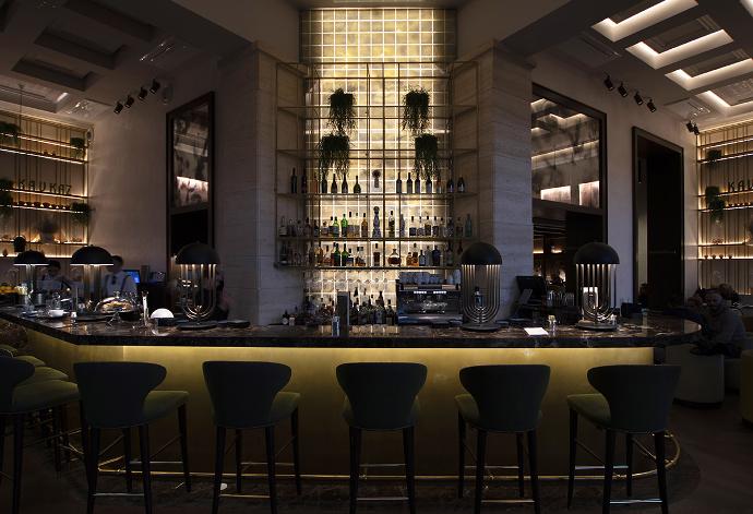 Exclusive interior of the cafe, with an illuminated bar and bar stools