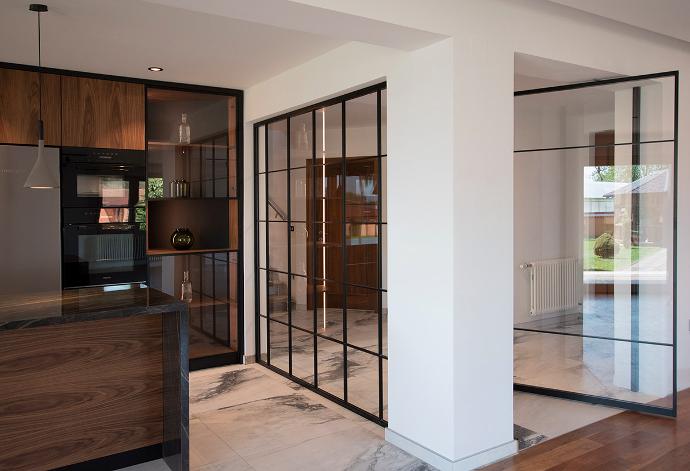 Modern kitchen interior with glass partition and door
