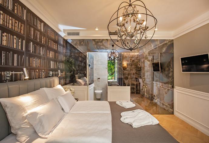 Luxury bedroom interior with antique mirrors, bed and chandelier