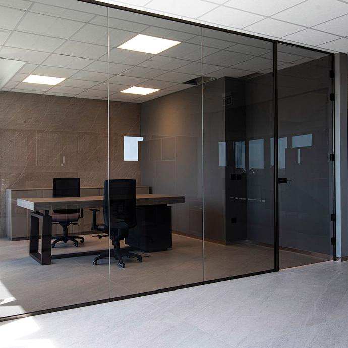 A modern office with a glass wall.