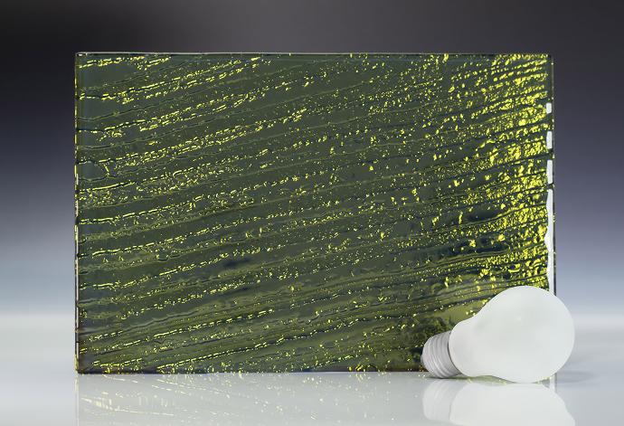 A square piece of green texture glass and a light bulb on a neutral background