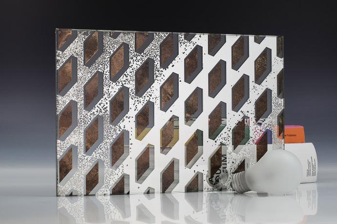 A square mirror piece with a geometric pattern, a light bulb and books on a neutral background
