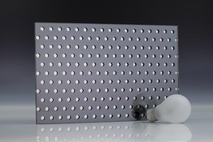A square piece of gray mirror with a dot pattern and a light bulb on a neutral background